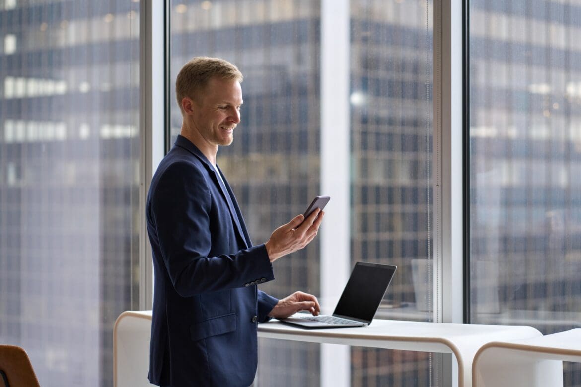 Investor checking Stocks and Shares ISA investments on mobile phone in the city